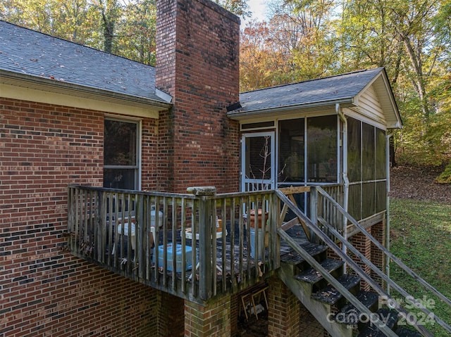 wooden deck with a sunroom