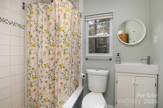 bathroom featuring walk in shower, vanity, and toilet