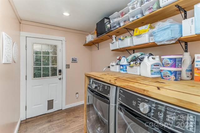 laundry area with wood-type flooring and washer and clothes dryer