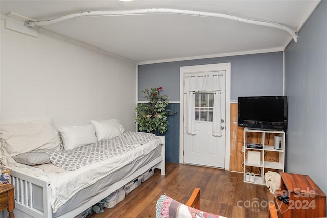 bedroom featuring dark wood-type flooring and crown molding