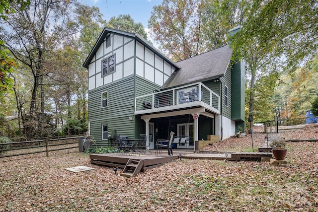 back of property featuring a wooden deck