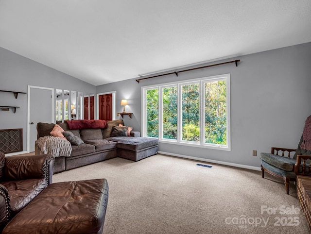 carpeted living room featuring lofted ceiling