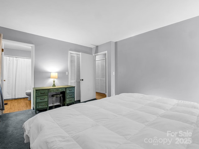 bedroom featuring connected bathroom and light wood-type flooring