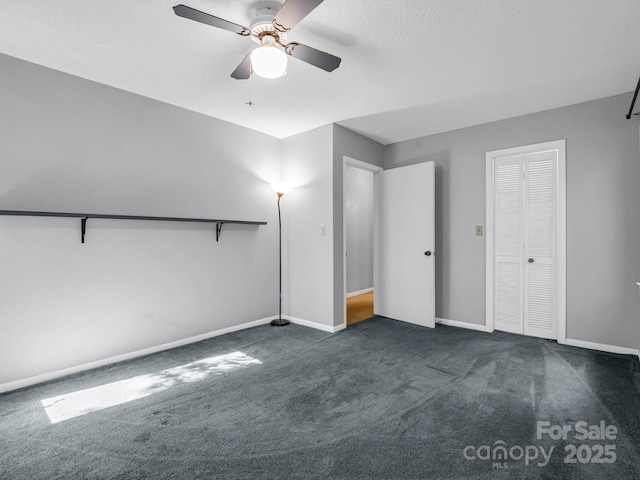 interior space with a textured ceiling, ceiling fan, and dark colored carpet