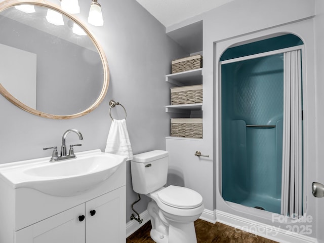 bathroom with vanity, a shower, wood-type flooring, and toilet