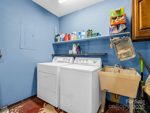 washroom with sink, cabinets, electric panel, washing machine and dryer, and a textured ceiling