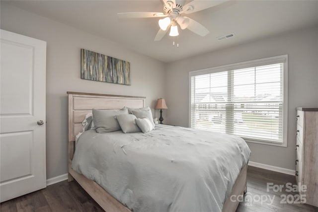 bedroom with visible vents, baseboards, and multiple windows