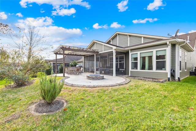 rear view of property with a patio, a fire pit, a lawn, and a sunroom