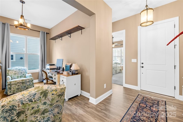 entrance foyer with ceiling fan, light wood-type flooring, and a wealth of natural light