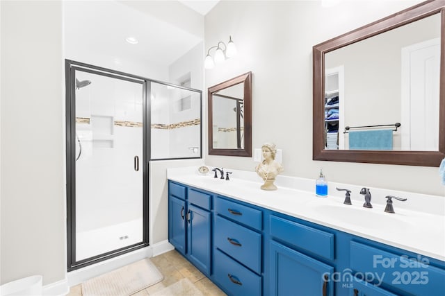 bathroom featuring tile patterned flooring, vanity, and an enclosed shower