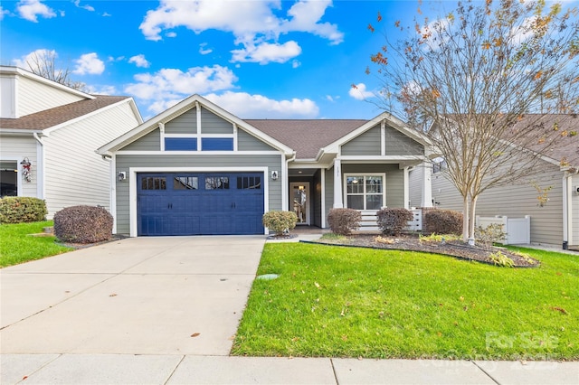 view of front of house featuring a front yard and a garage