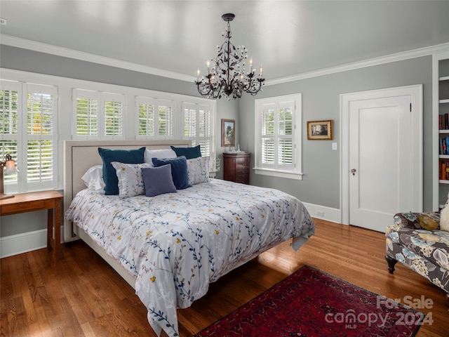 bedroom with crown molding, an inviting chandelier, multiple windows, and dark hardwood / wood-style floors