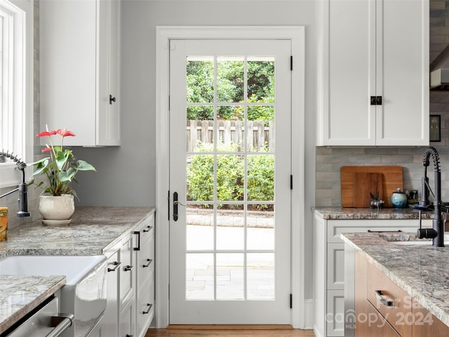 doorway to outside with sink and light hardwood / wood-style flooring