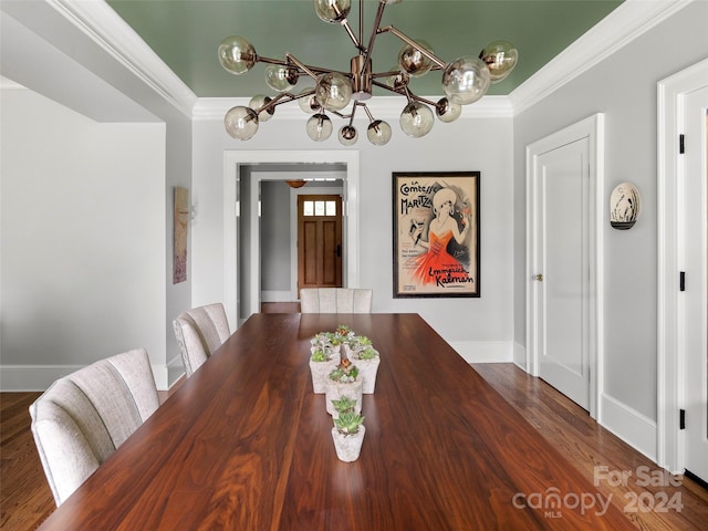 dining area with an inviting chandelier, crown molding, and dark hardwood / wood-style floors