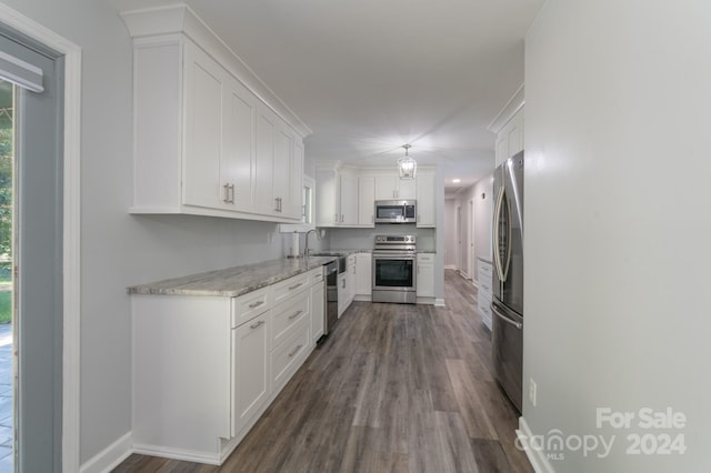 kitchen featuring white cabinets, appliances with stainless steel finishes, dark hardwood / wood-style floors, sink, and light stone counters