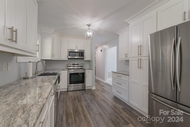 kitchen featuring hanging light fixtures, stainless steel appliances, sink, white cabinets, and dark hardwood / wood-style flooring