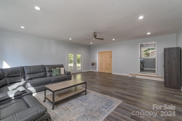 living room featuring dark wood-type flooring, ceiling fan, french doors, and heating unit