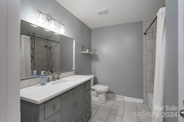 full bathroom with toilet, shower / bath combo, vanity, and tile patterned floors