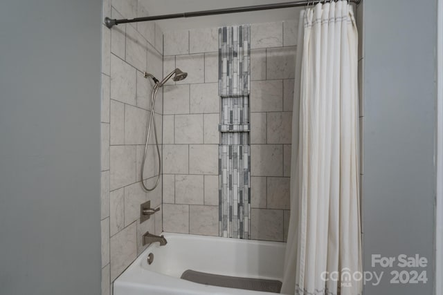 bathroom featuring shower / bathtub combination with curtain