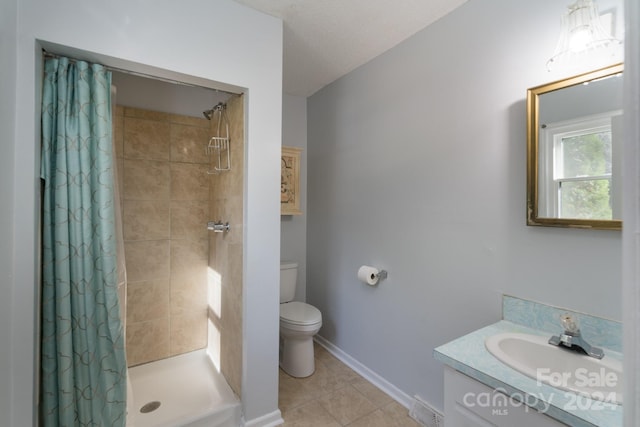 bathroom with vanity, curtained shower, toilet, and tile patterned flooring