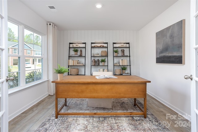 office with plenty of natural light and hardwood / wood-style floors