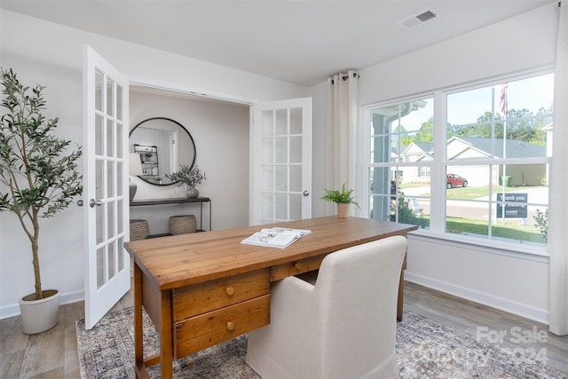 dining room with french doors and hardwood / wood-style flooring