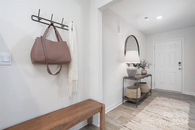 mudroom with light hardwood / wood-style floors