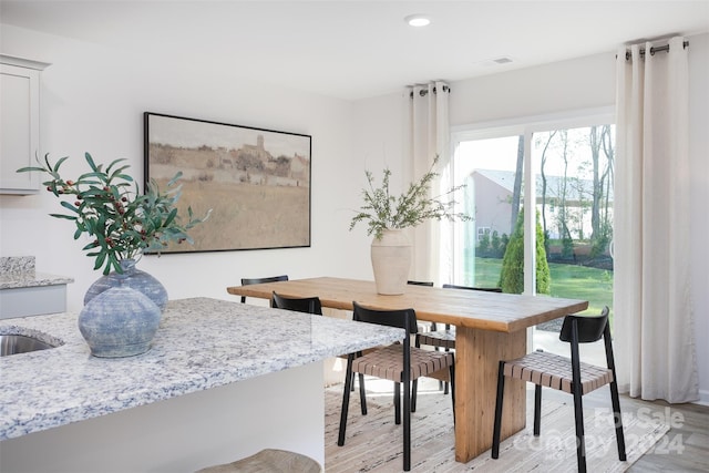 dining space with light hardwood / wood-style flooring