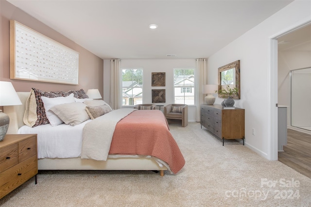 bedroom featuring light carpet