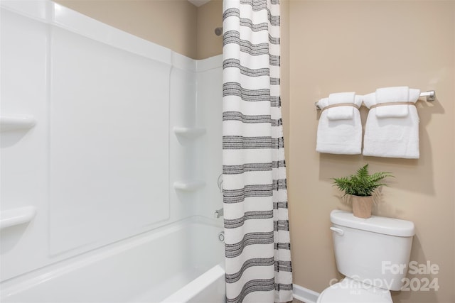 bathroom with toilet and shower / bath combination with curtain