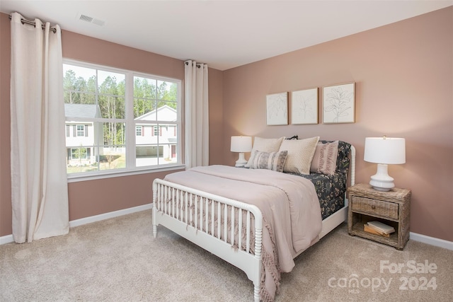 bedroom with light colored carpet