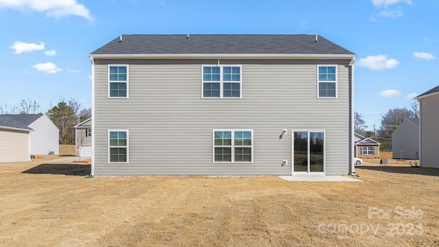 back of house with a yard and a patio area