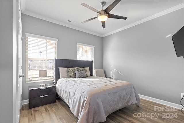 bedroom featuring ornamental molding, hardwood / wood-style flooring, and ceiling fan