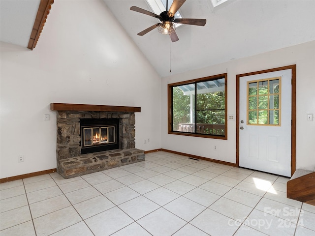 unfurnished living room with light tile patterned flooring, a stone fireplace, ceiling fan, beamed ceiling, and high vaulted ceiling