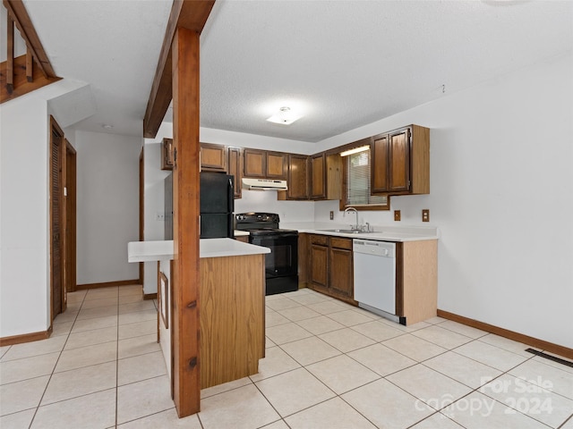 kitchen featuring light tile patterned floors, a textured ceiling, black appliances, and sink