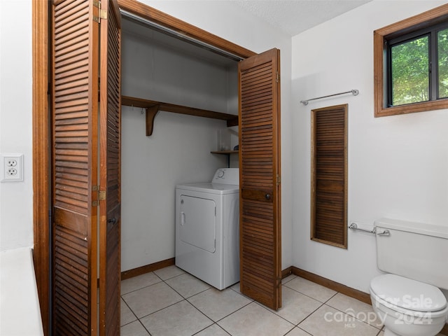 laundry room featuring washer / dryer and light tile patterned floors