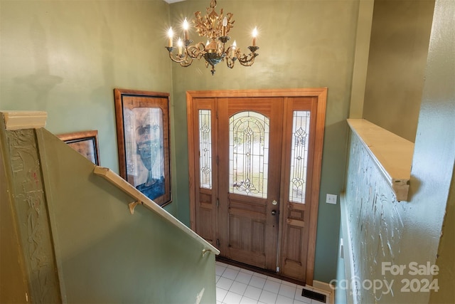 foyer entrance with light tile patterned flooring and a notable chandelier