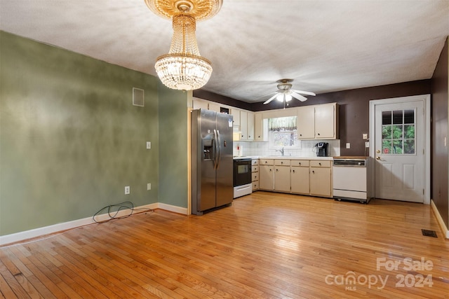 kitchen featuring ceiling fan with notable chandelier, white cabinets, sink, light wood-type flooring, and white appliances