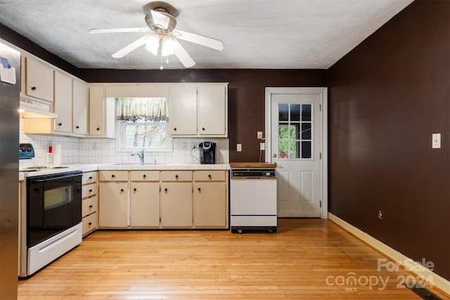 kitchen with decorative backsplash, sink, exhaust hood, light hardwood / wood-style flooring, and white appliances