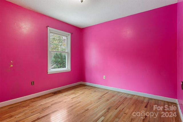 empty room with light hardwood / wood-style floors