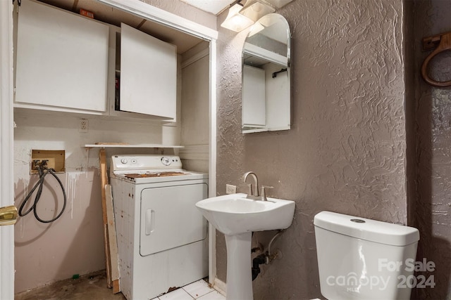 bathroom with toilet and washer / clothes dryer