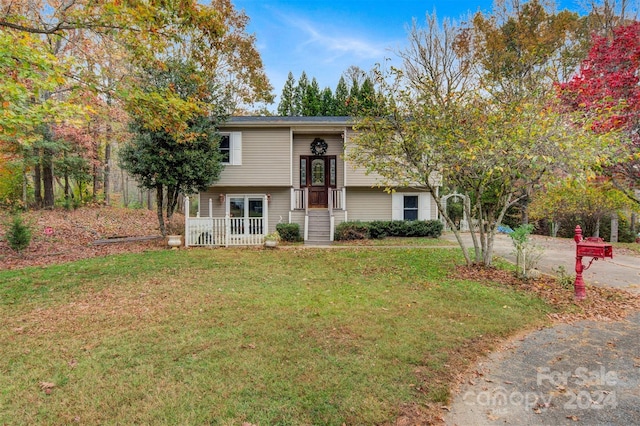 raised ranch with a front yard