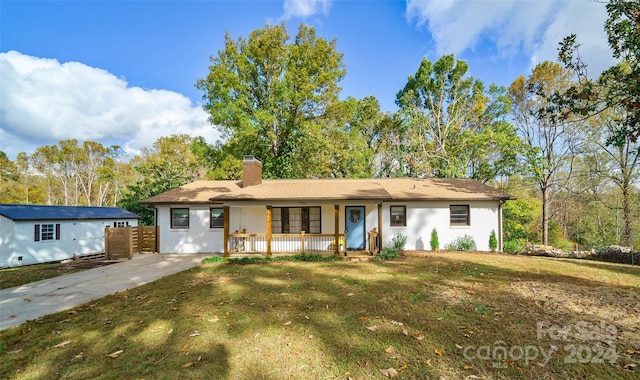 single story home with a front lawn and a porch