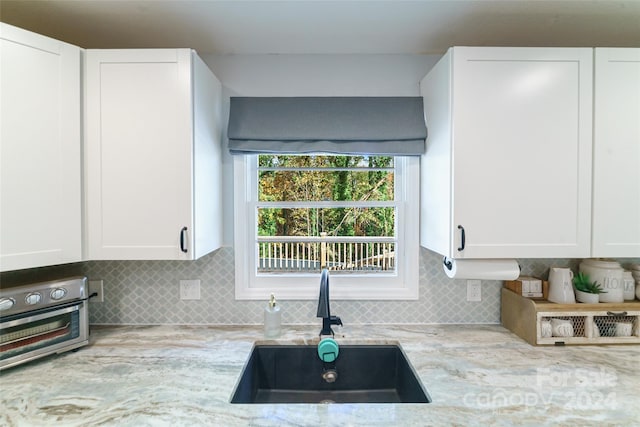 kitchen with white cabinetry and sink