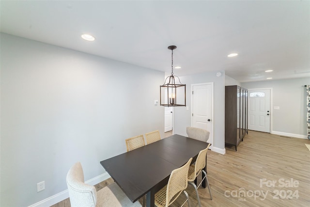 dining area featuring a chandelier and light wood-type flooring