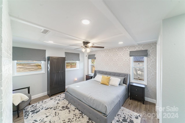 bedroom with light hardwood / wood-style floors and ceiling fan