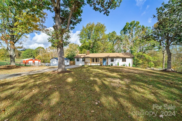 single story home with a front lawn and a patio