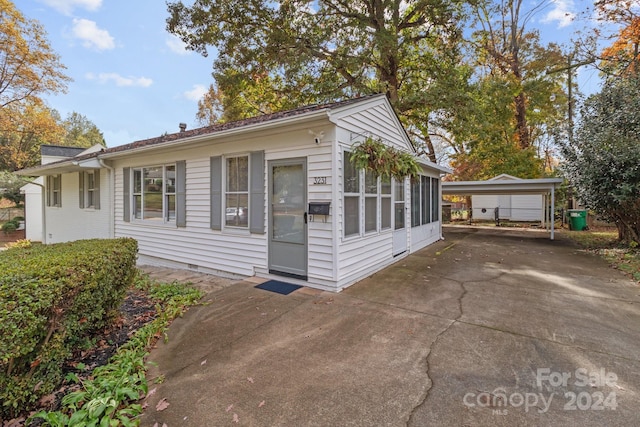 view of home's exterior with a carport