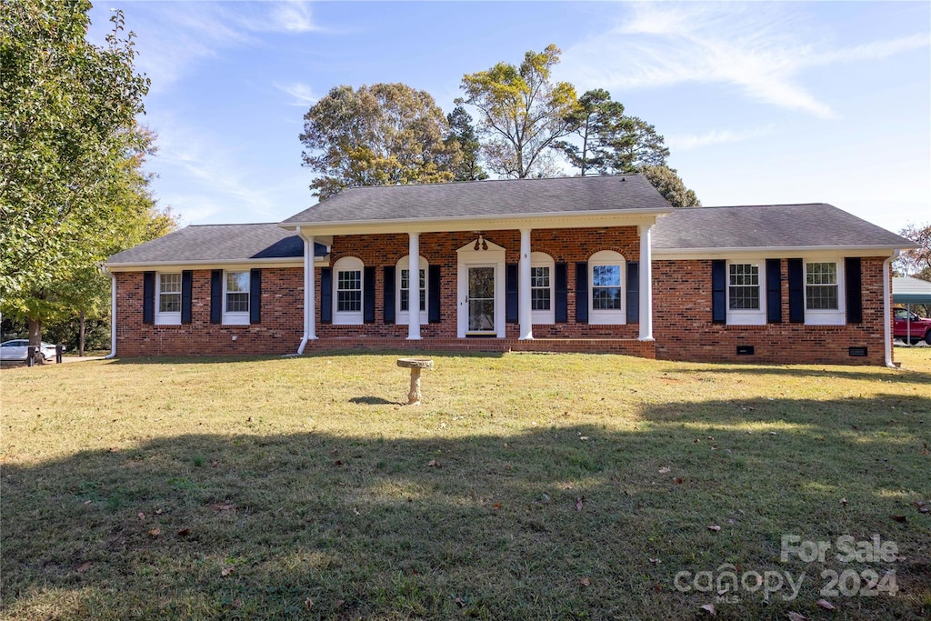 ranch-style house with a front lawn