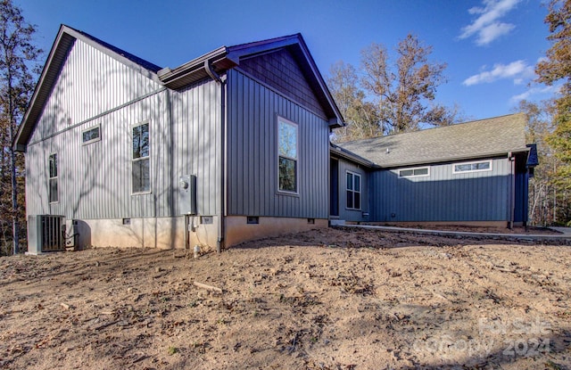 view of side of home featuring central AC unit